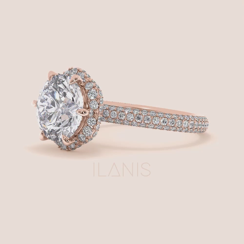 Video of Exquisite rose gold engagement ring featuring a halo of pavé-set diamonds around a radiant cushion-cut center stone, mounted on a fully diamond-encrusted band. | #14KRecycledRoseGold #18KRecycledRoseGold