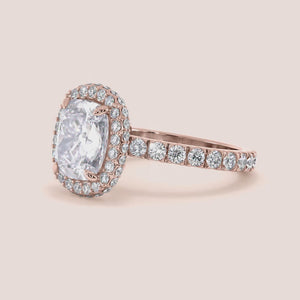 Rose gold teardrop halo engagement ring set featuring pear-shaped diamond, with options in 14K, 18K, or platinum settings.