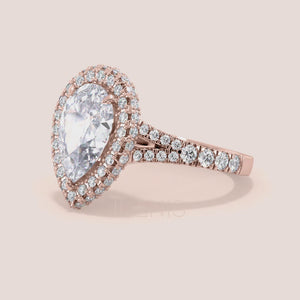 Rose gold pear diamond halo engagement ring with pavé band, intricate side view highlighting craftsmanship and brilliance 