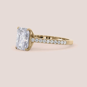 Elegant radiant-cut diamond engagement ring in classic yellow gold, available in 14K and 18K, featuring a stunning diamond-studded band.
