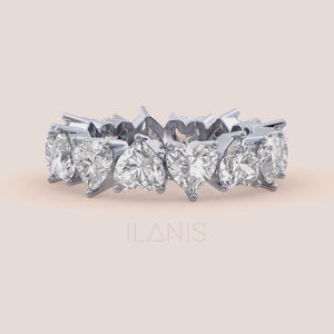 Close-up video of heart shaped diamond eternity ring in white gold, capturing sparkle, prong craftsmanship and full eternity brilliance in motion 