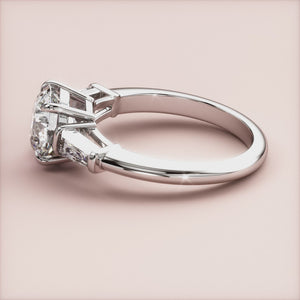 "White Gold 14K/18K engagement ring featuring round three-stone and tapered baguettes, perfect for timeless elegance.