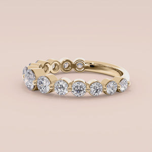 Elegant 14K gold wedding band with shared prong round brilliant diamonds, perfect for special occasions or everyday elegance. 