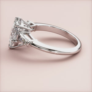 14K White Gold Butterfly Engagement Ring with Pear-Shaped Diamond and Trapezoid Cut Side Stones on Beige Background.
