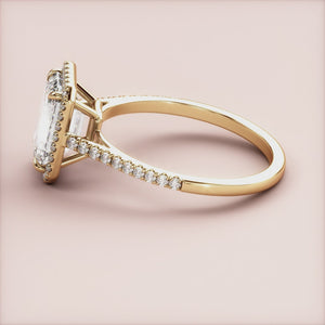 Elegant emerald-cut diamond ring in 14K yellow gold, featuring a sparkling halo and pave band, ideal for engagements.