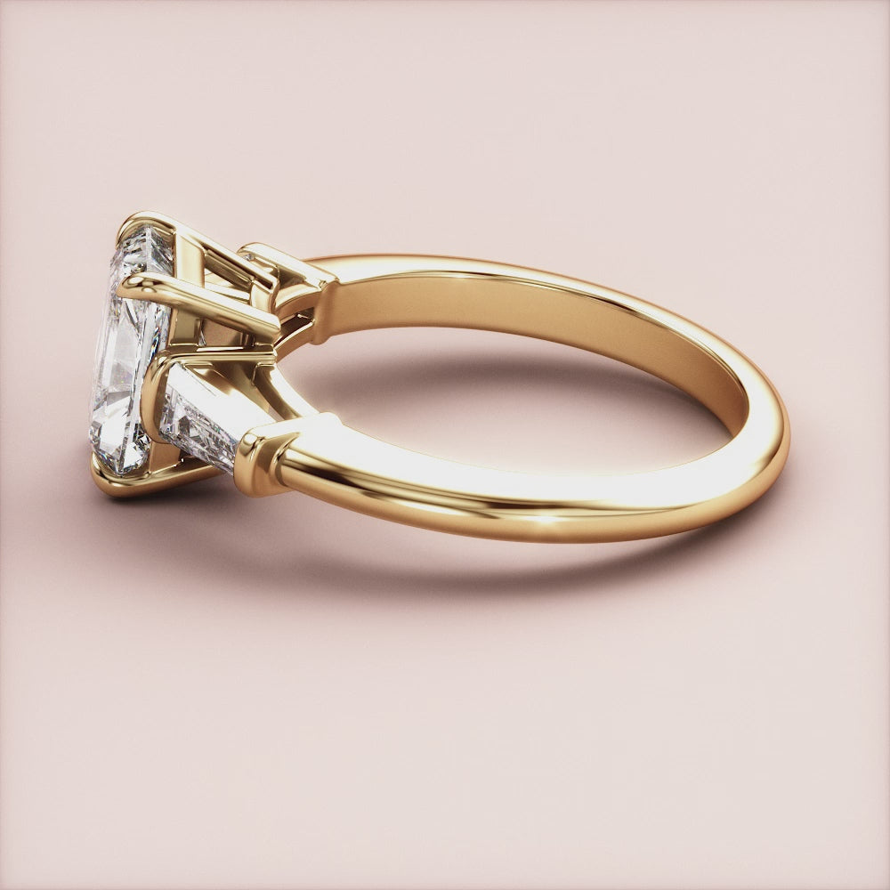 "14K Yellow Gold Lyra Radiant Three-Stone Tapered Baguette Engagement Ring, a stunning symbol of love and elegance.|




#14KRecycledYellowGold
#18KRecycledYellowGold





"
