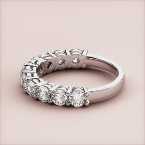 Elegant 14K or 18K gold or platinum three-quarter eternity wedding band with brilliant round-cut diamonds, showcasing timeless luxury. 