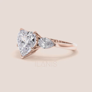 Video of Rose gold engagement ring with a heart-shaped main diamond and elegant teardrop diamonds, designed for a luxurious and timeless proposal. 