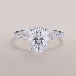 "Elegant 14K white gold Polaris oval engagement ring with hidden halo, prong accents, and pave band for timeless romance.