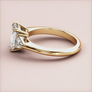 "14K yellow gold three-stone triangle engagement ring with emeralds, a stunning choice for an unforgettable proposal.
