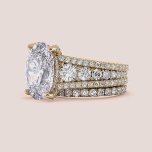 """14K Yellow Gold oval halo engagement ring with prong accents, featuring a stunning three-row band design.""