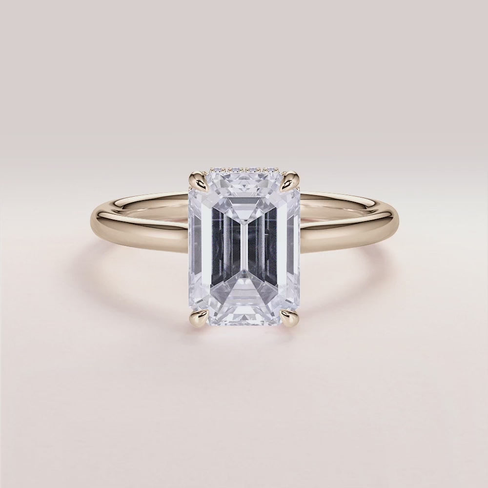 Elegant emerald-cut diamond solitaire engagement ring in yellow gold, available in 14K, 18K, or platinum, featuring a hidden halo.
#14KRecycledYellowGold
#18KRecycledYellowGold