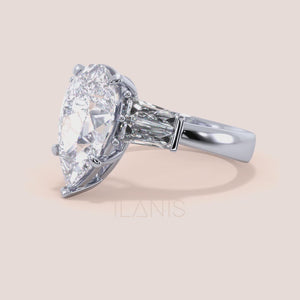 Pear cut diamond three stone engagement ring in white gold, close-up rotating video featuring baguette side stones and refined prong setting with strong brilliance 