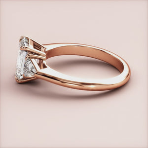 "Rose Gold 14K Emerald Three Stone Triangle Engagement Ring, a stunning choice for couples seeking elegance and timeless beauty.