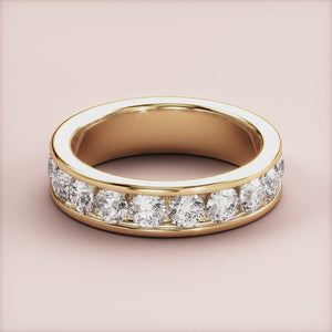 Elegant 14K gold channel-set diamond eternity band featuring brilliant-cut round diamonds, perfect as a wedding or anniversary ring. 