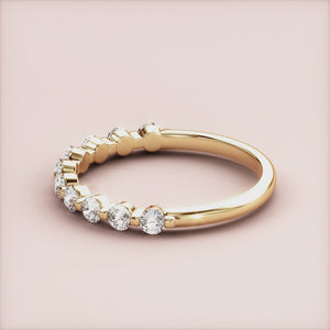 Elegant 14K or 18K yellow gold eternity band with round brilliant-cut diamonds, perfect for timeless wedding jewelry. 