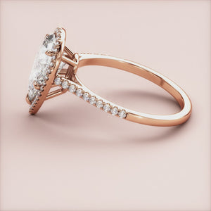 Elegant 14K rose gold engagement ring featuring a stunning pear-shaped diamond with a halo of smaller diamonds on a soft blush background.