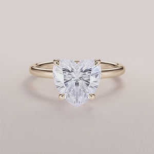 Elegant 14K yellow gold engagement ring featuring the Halley heart classic solitaire design with a stunning trillion-cut diamond.