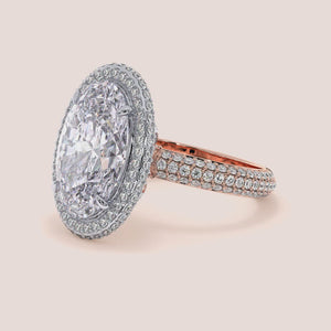 Two-tone 14K white and rose gold oval diamond engagement ring with halo design and pave detailing. Perfect for love! 