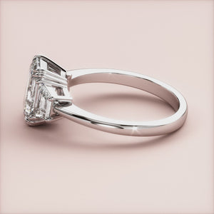 "Elegant White Gold 14K & 18K engagement ring featuring a stunning emerald three-stone trapezoid design, perfect for unique proposals.