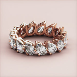 Stunning 14K/18K gold or platinum teardrop diamond eternity wedding band, showcasing exquisite craftsmanship in a continuous loop. 