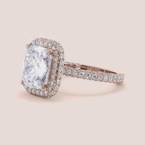 Rose gold teardrop halo engagement ring set featuring pear-shaped diamond, with options in 14K, 18K, or platinum settings.