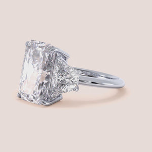 "Elegant 14K white gold radiant three-stone trapezoid engagement ring, showcasing timeless beauty and sophistication.