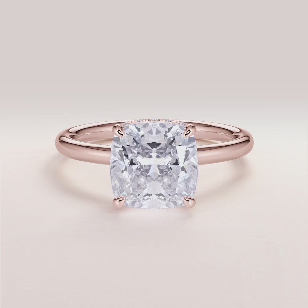 "Rose Gold 14K engagement ring featuring an Oberon cushion cut with an invisible gallery, hidden halo, and plain band.|







#14KRecycledRoseGold
#18KRecycledRoseGold


"
