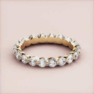 Elegant yellow gold eternity wedding band featuring round-cut diamonds in a seamless design, available in 14K or 18K. 