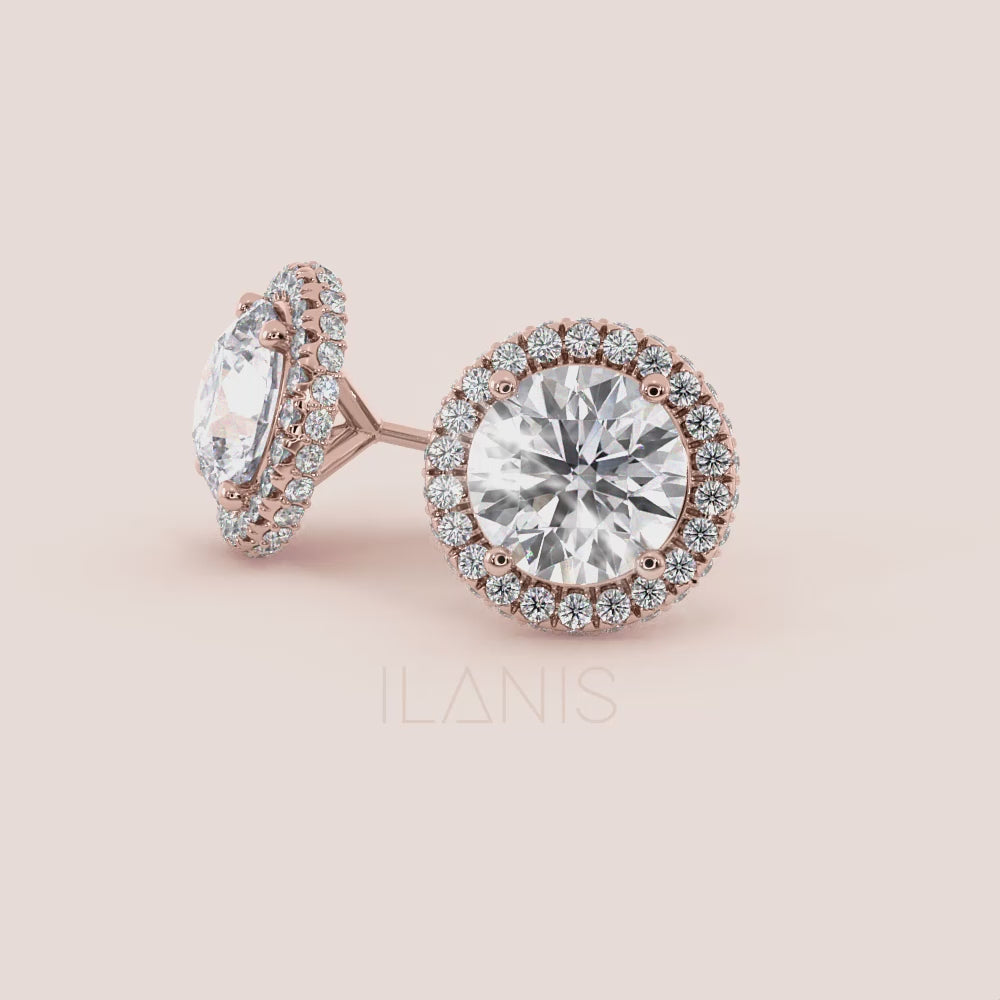 Close-up video of signature round halo diamond stud earrings in rose gold, capturing light reflection, halo sparkle and fine setting details in motion | #14KRecycledRoseGold #18KRecycledRoseGold