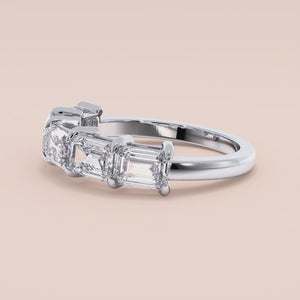 14K or 18K white gold wedding band featuring five radiant baguette-cut diamonds in a prong setting.  Elegant and timeless design. 