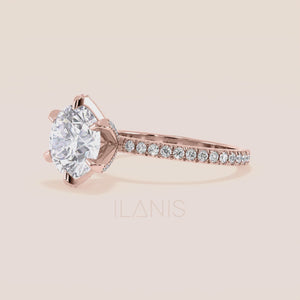 Close-up video of rose gold round diamond engagement ring with pavé band, capturing light reflection, diamond brilliance and fine setting details in motion 