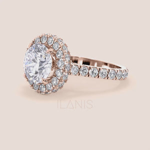 Elegant rose gold engagement ring with a brilliant round-cut diamond center, encircled by a dazzling halo of smaller diamonds, adding opulence and sparkle. 