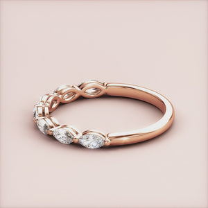 14K and 18K rose gold marquise-cut diamond eternity wedding band, featuring a sleek design and continuous row of dazzling diamonds. 