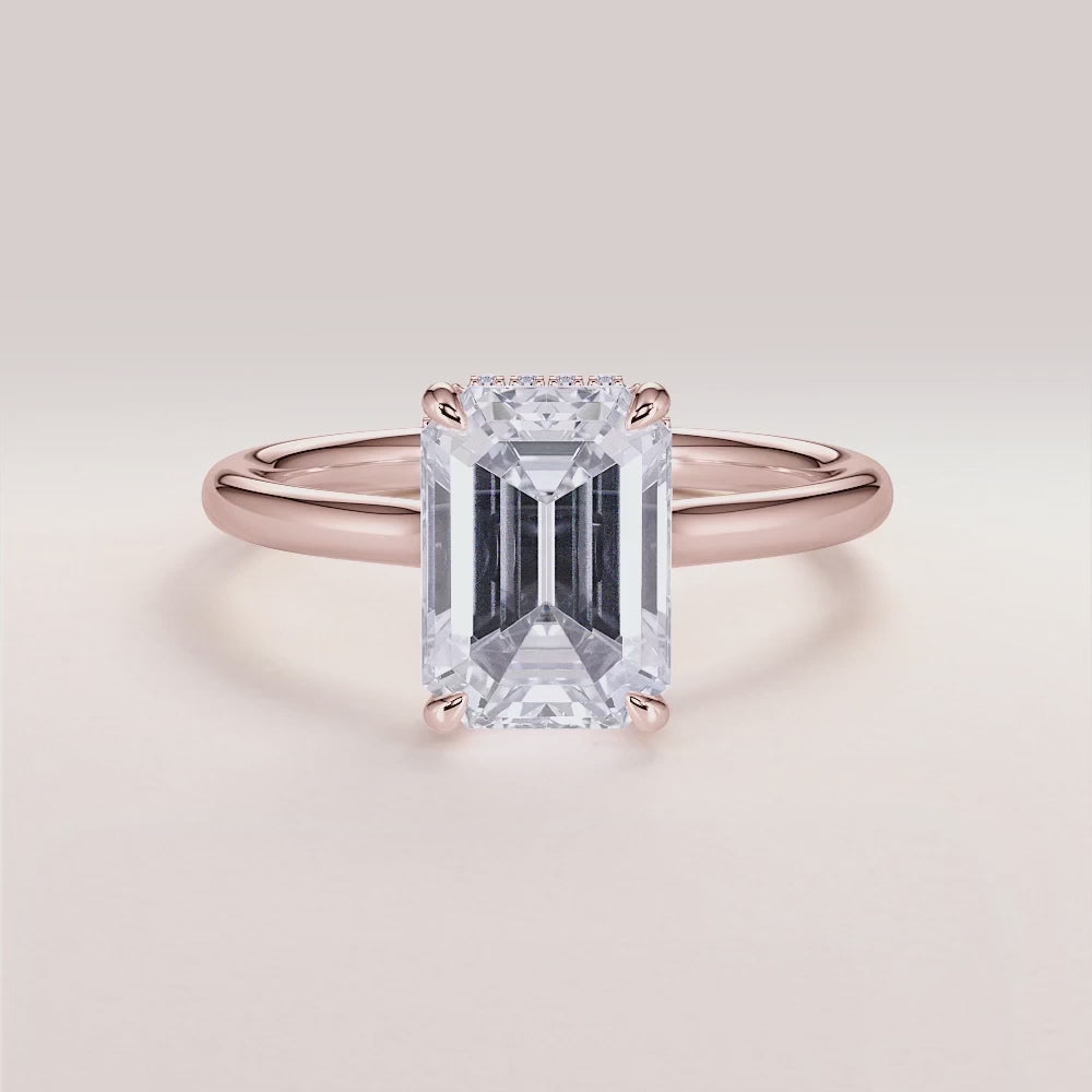 "Rose gold 14K engagement ring featuring an emerald, invisible gallery, hidden halo, and plain band design. Perfect for unique proposals.|







#14KRecycledRoseGold
#18KRecycledRoseGold


"

