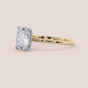 Two-tone 14K/18K gold solitaire diamond ring featuring a cushion cut stone, perfect for engagement. White and yellow gold design. 