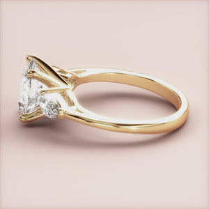 "14K Yellow Gold Titania Oval Three Stone Pear Engagement Ring - Elegant design perfect for timeless love.