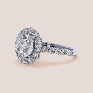Elegant flower-shaped diamond ring with a round diamond centerpiece in a 14K or 18K white gold or platinum band, not worn.
