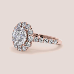 Exquisite halo engagement ring showcasing a round diamond in a stunning 14K or 18K gold or platinum band with smaller sparkling diamonds.
