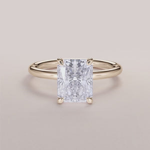 Elegant 14K/18K yellow gold solitaire engagement ring with marquise-cut diamond on a light background.