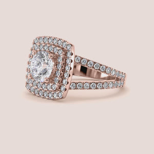 Elegant cushion-cut diamond engagement ring in 14K, 18K, or platinum with a dazzling halo design, worn by a model.
