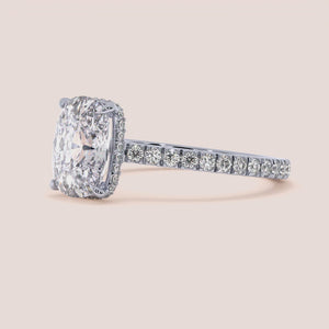 Elegant oval diamond halo engagement ring in 14K or 18K gold, featuring a stunning oval center diamond and a diamond-studded band.