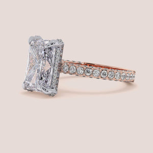 Two-tone white and rose gold diamond ring in radiant shape, featuring exquisite 18K gold design and hidden halo details. 
