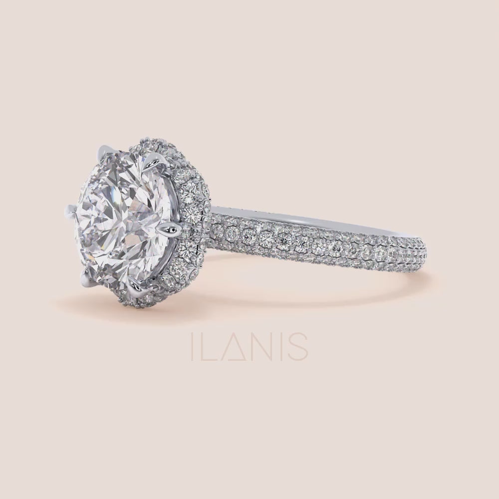 Video of Exquisite white gold engagement ring featuring a halo of pavé-set diamonds around a radiant cushion-cut center stone, mounted on a fully diamond-encrusted band. | #14KRecycledWhiteGold #18KRecycledWhiteGold #Platinum