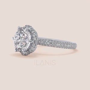 Video of Exquisite white gold engagement ring featuring a halo of pavé-set diamonds around a radiant cushion-cut center stone, mounted on a fully diamond-encrusted band. 