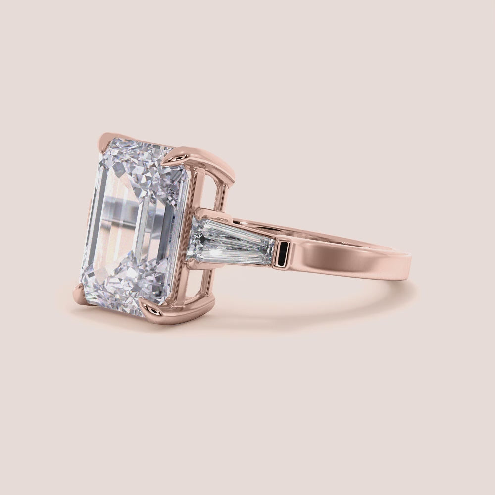 "Elegant 14K rose gold emerald three-stone tapered baguette engagement ring, perfect for expressing timeless love.|







#14KRecycledRoseGold
#18KRecycledRoseGold


"
