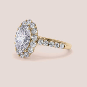 Elegant oval diamond ring with a stunning oval diamond center, set in 14K or 18K gold or platinum, complete with a diamond halo.
