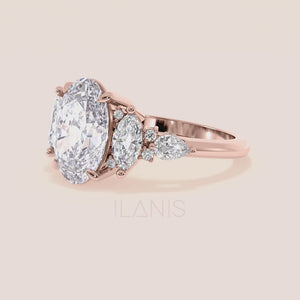 Oval three stone diamond engagement ring yellow gold with pear side stones on hand, elegant oval cut center diamond ring for proposal inspiration, modern luxury bridal jewelry 