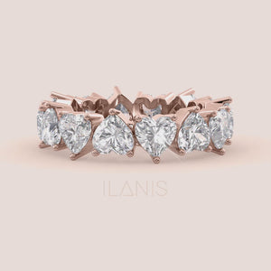 Close-up video of heart shaped diamond eternity band in rose gold, showcasing sparkle, prong setting details and continuous diamond brilliance in motion 