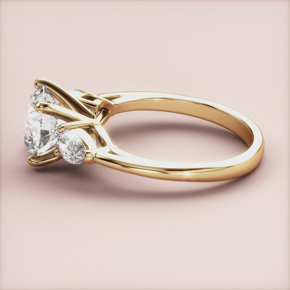 "14K Yellow Gold Round Three Stone Pear Engagement Ring - Elegant, timeless design perfect for proposals and celebrations.|




#14KRecycledYellowGold
#18KRecycledYellowGold





"

